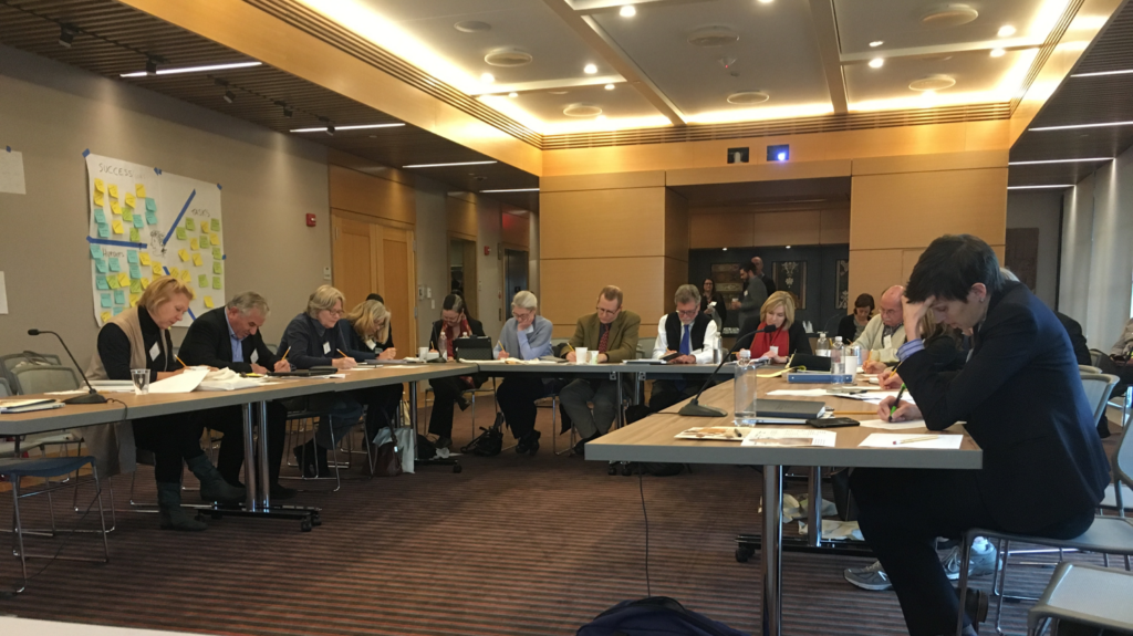 Workshop in a conference room, with people sitting around tables