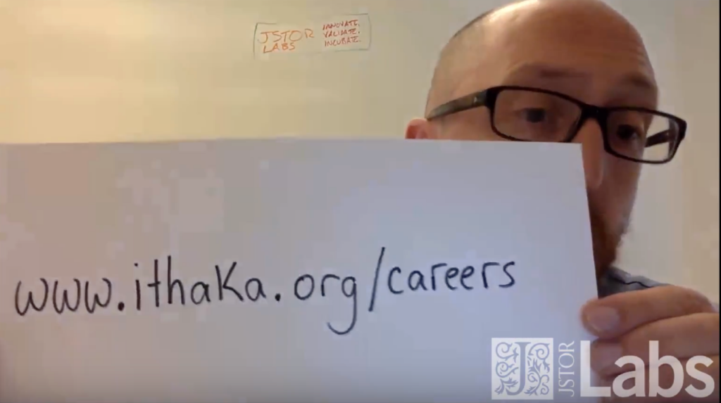 Alex Humphreys holding up a sign with www.ithaka.org/careers